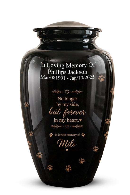 A glossy black pet memorial urn with a matching lid, featuring personalized white and gold text and small paw print details, shown on a clean white background.