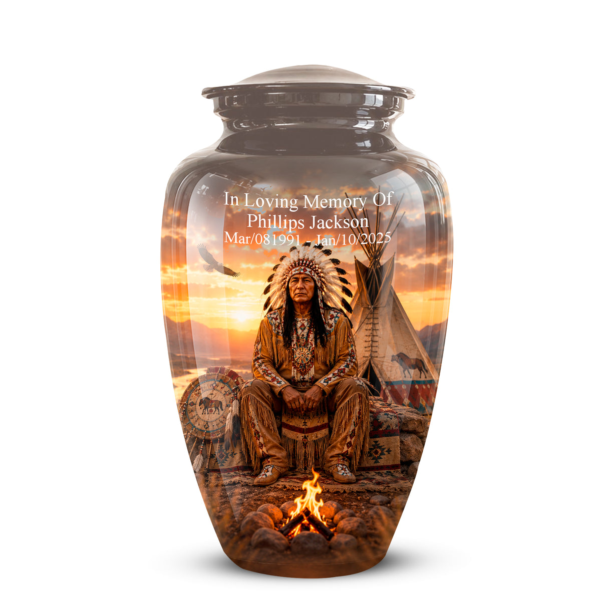 A dark brown ceramic cremation urn with a lid, featuring a detailed custom print of a Native American warrior, a teepee, and a campfire under a sunset sky. White text on the upper left reads 'In Loving Memory Of Phillips Jackson' with birth and death dates.