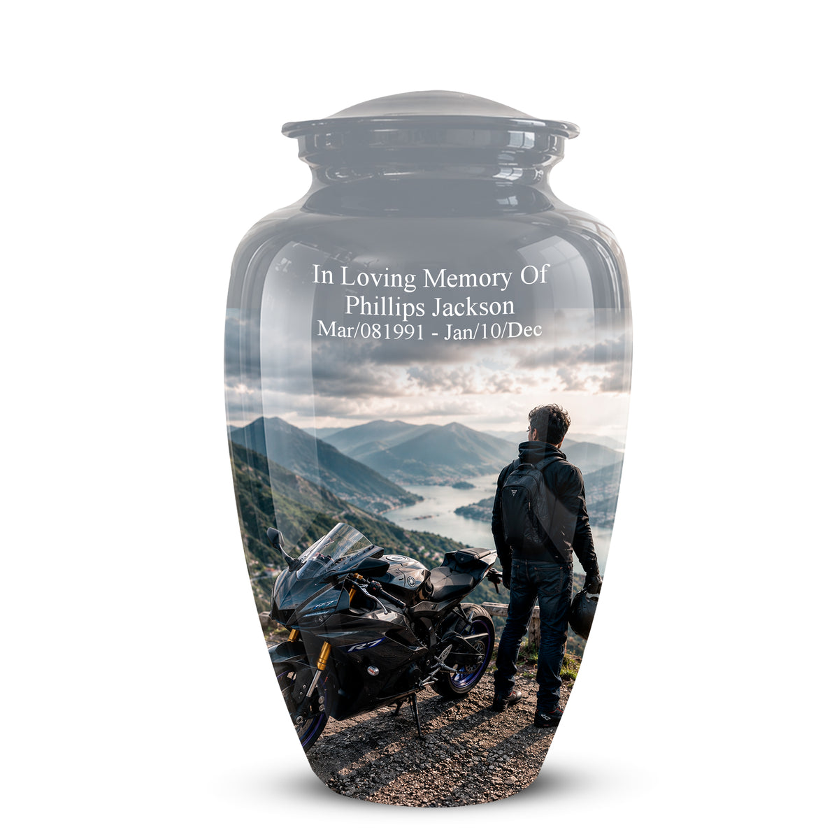 A glossy black glass cremation urn with a custom printed scenic photo of a motorcycle and a man looking at mountains, featuring white memorial text on the front, shown on a white background.