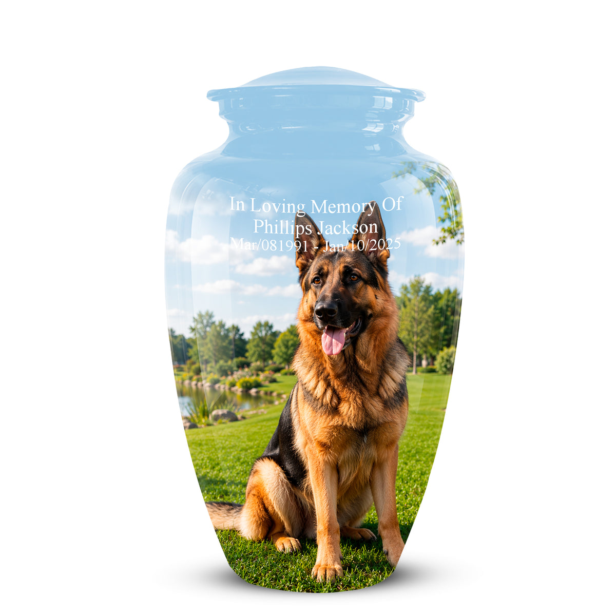 A clear glass pet memorial urn with a lid, featuring a printed photo of a German Shepherd sitting on a green lawn under a blue sky. White text on the front reads 'In Loving Memory Of Phillips Jackson' with dates below.