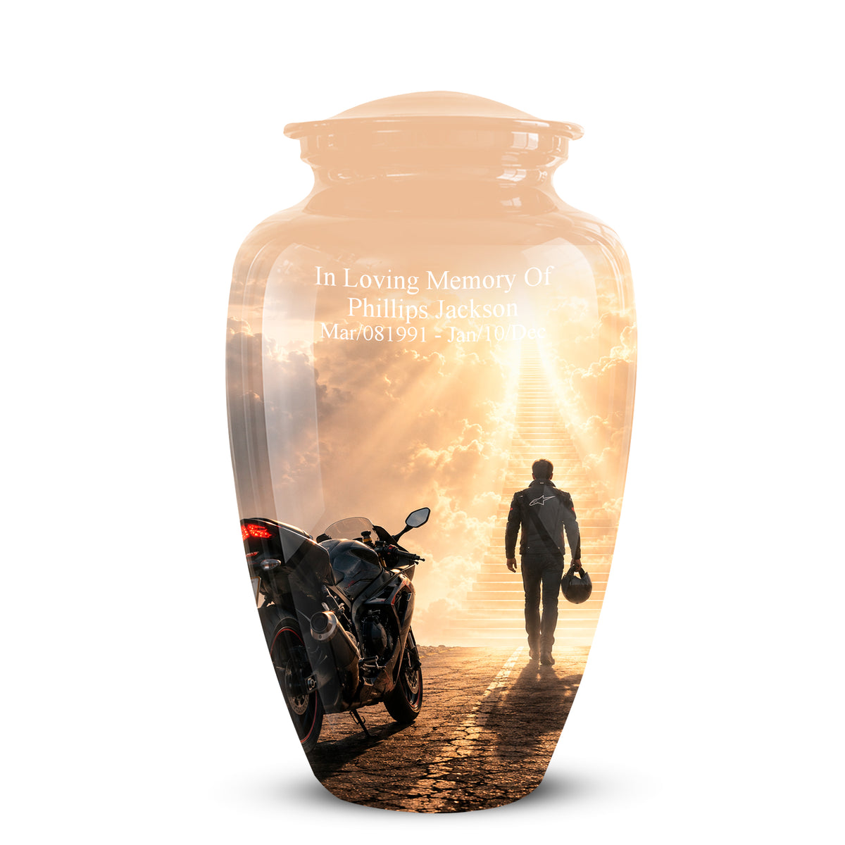 A clear glass memorial urn with a lid, featuring a printed sunset scene of a motorcycle and a person walking toward a bright horizon. White engraved text on the front reads, 'In Loving Memory Of Phillips Jackson' with dates below, shown on a white background.