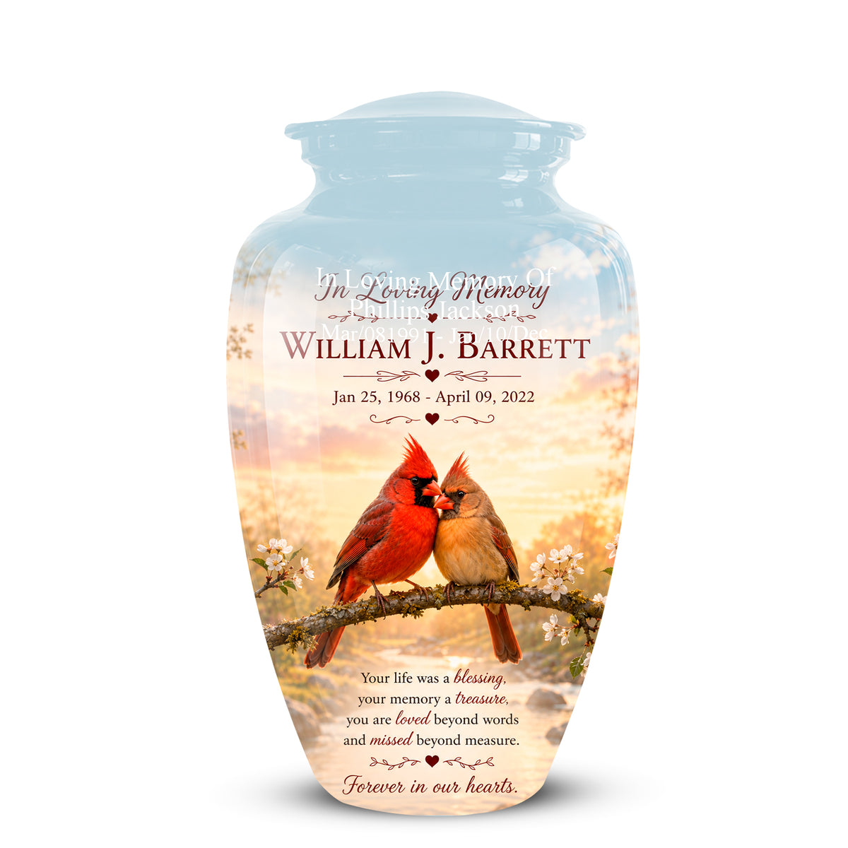 A personalized glass cremation urn with a lid, featuring a printed design of two cardinal birds on a branch against a sunset sky. The text on the urn reads 'In Loving Memory William J.