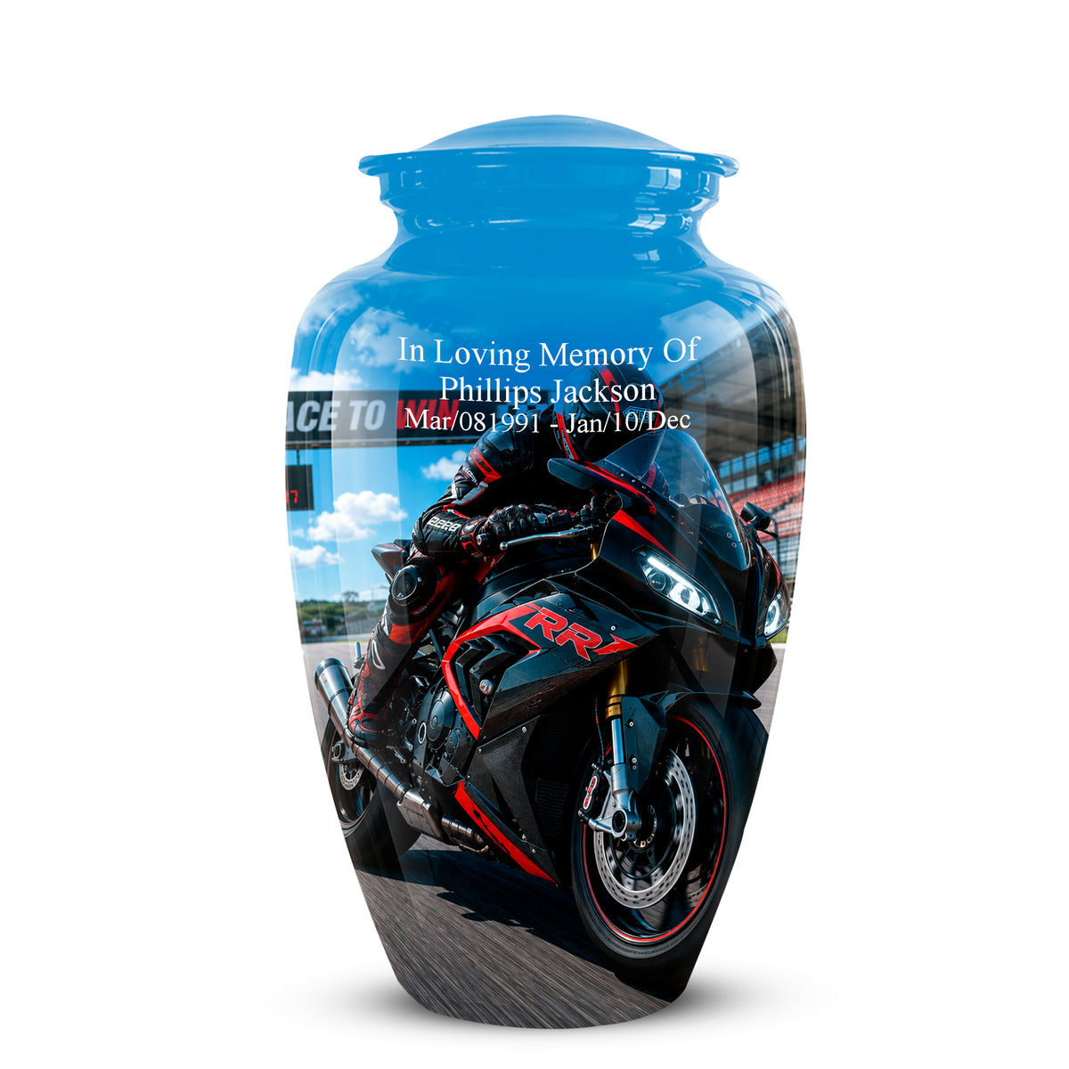A glossy blue memorial urn featuring a printed graphic of a black and red sport motorcycle with a rider, and personalized white text reading 'In Loving Memory OF Phillips Jackson Mar/08/1991 - Jan/10/Dec'.