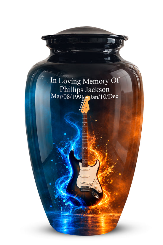 A glossy black ceramic cremation urn with a lid, featuring a custom printed design of a white electric guitar split by blue and orange flame-like energy effects. White personalized text is printed near the top, reading 'In Loving Memory Of Phillips Jackson' with dates below.