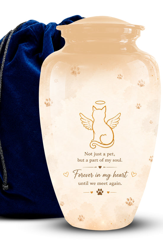 A glossy cream-colored ceramic pet memorial urn with gold engraved text and paw print details, shown next to a dark blue velvet drawstring bag on a white background.