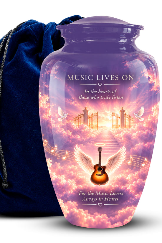 A purple glass cremation urn with a colorful sky and angel guitar design, shown next to a dark blue velvet drawstring bag on a white background.
