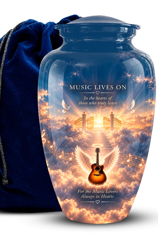 A personalized glass cremation urn with a blue glass lid and base, featuring a printed sunset sky design with an angel guitar, wings, and the text 'MUSIC LIVES ON'. A dark blue velvet drawstring bag sits behind it on a white background.