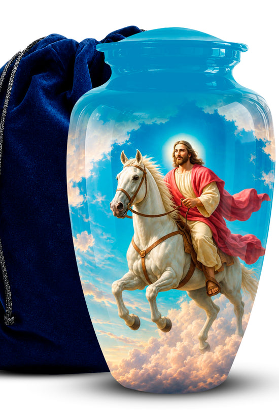 A glossy glass urn-shaped vase featuring a printed illustration of Jesus riding a white horse through clouds, shown next to a dark blue velvet drawstring bag on a white background.