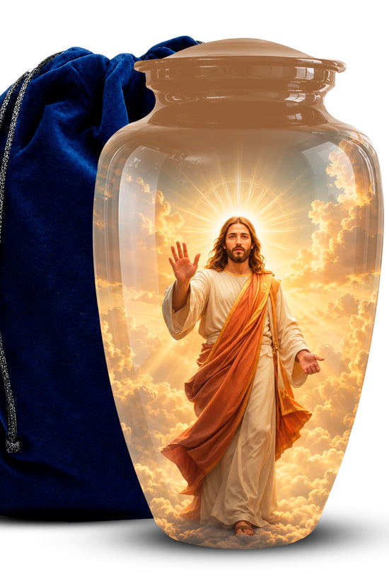 A clear glass or acrylic cremation urn with a lid, featuring a printed or embedded image of Jesus standing in clouds with a radiant halo. A dark blue velvet drawstring bag is placed behind it on a white background.