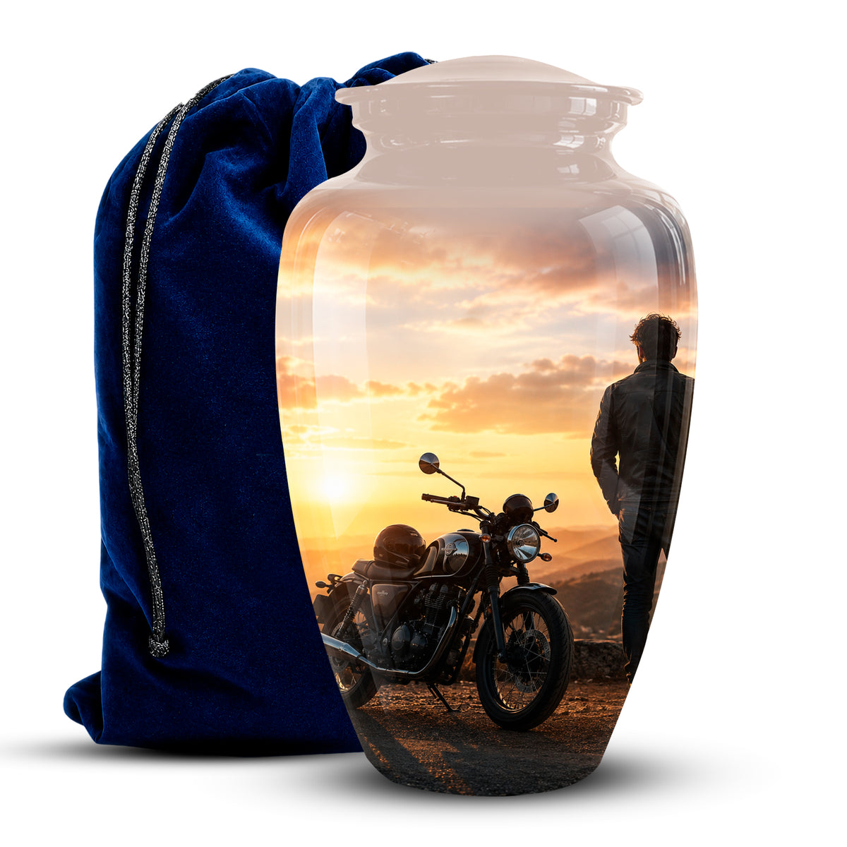A clear glass urn-shaped vase with a printed scenic photo of a motorcycle and a person at sunset, shown next to a blue velvet drawstring bag on a white background.