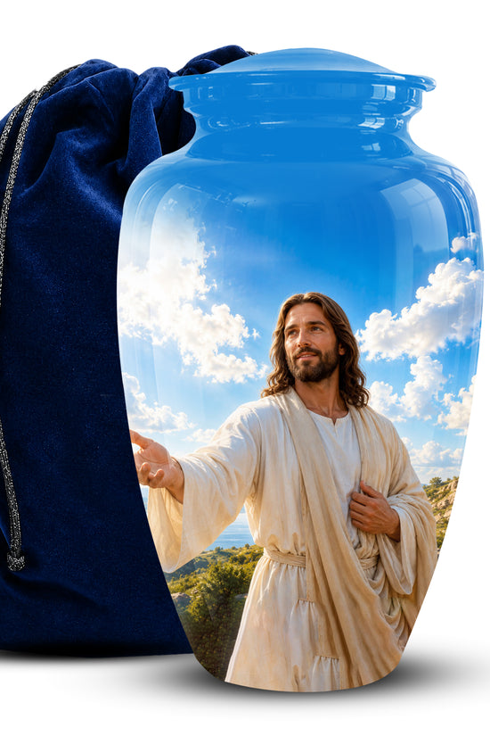 A glossy blue cremation urn featuring a printed image of Jesus Christ on the front, shown next to a dark blue velvet drawstring bag on a white background.
