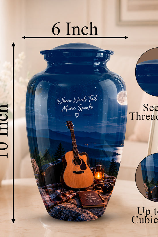 A personalized ceramic memorial urn vase with a blue night-sky and mountain landscape print, featuring an acoustic guitar and a book. The image includes dimension lines showing the product is 10 inches tall and 6 inches wide at the top, with circular inset images highlighting the secure threaded lid and the custom print detail.