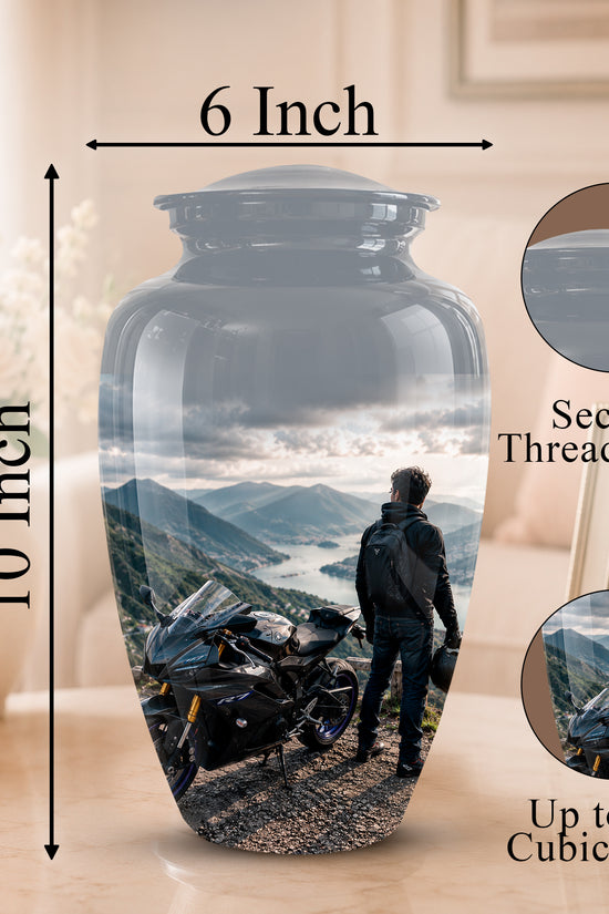 A 10-inch by 6-inch glass cremation urn with a custom photo print of a motorcyclist and mountain scenery, shown on a table with dimension arrows, a secure threaded lid inset, and a 200 cubic inch capacity inset.