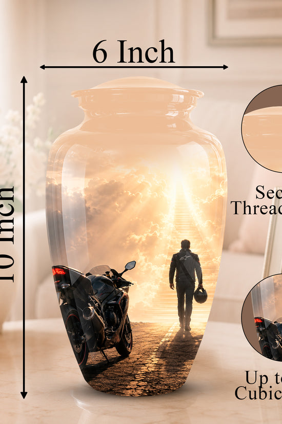 A large decorative vase shown on a tabletop in a softly lit room, with measurement arrows indicating 10 inch height and 6 inch width. The vase has a printed scenic design featuring a motorcycle, a person walking toward bright light, and sun rays.