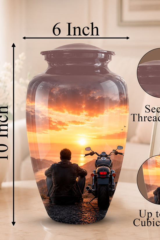 A 10-inch by 6-inch ceramic memorial urn with a sunset motorcycle scene printed on it, shown on a tabletop with dimension arrows, a threaded lid inset, and capacity text.