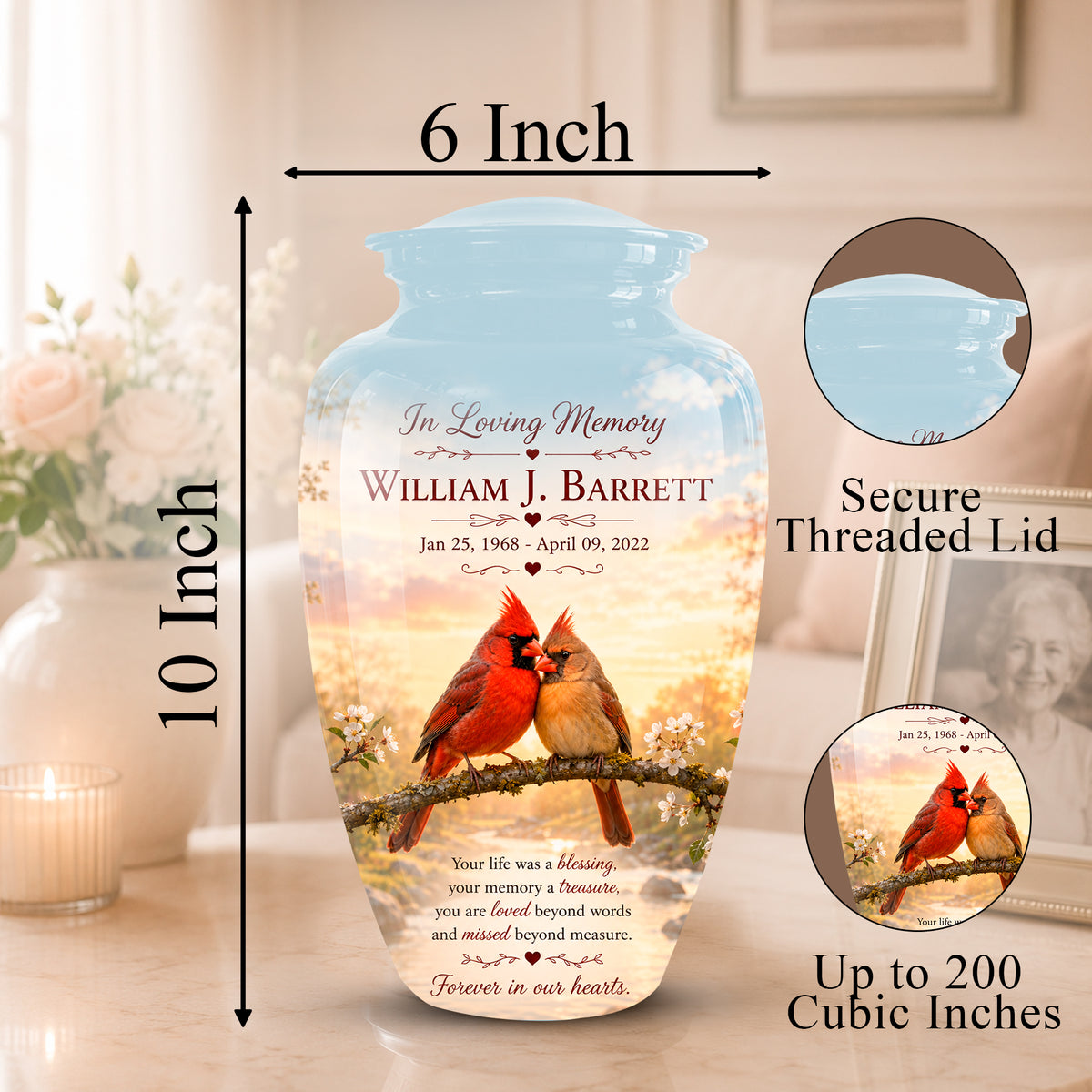 Personalized ceramic memorial vase with a threaded lid, shown on a tabletop with dimension labels indicating 6 inch width and 10 inch height. The vase features a printed design of a red cardinal on a branch against a warm sunset sky, with memorial text reading 'In Loving Memory William J.
