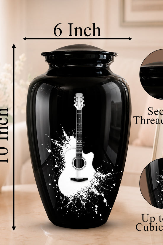 Black ceramic urn with a white guitar print and size measurement labels, shown on a tabletop with decorative background elements and inset detail circles.