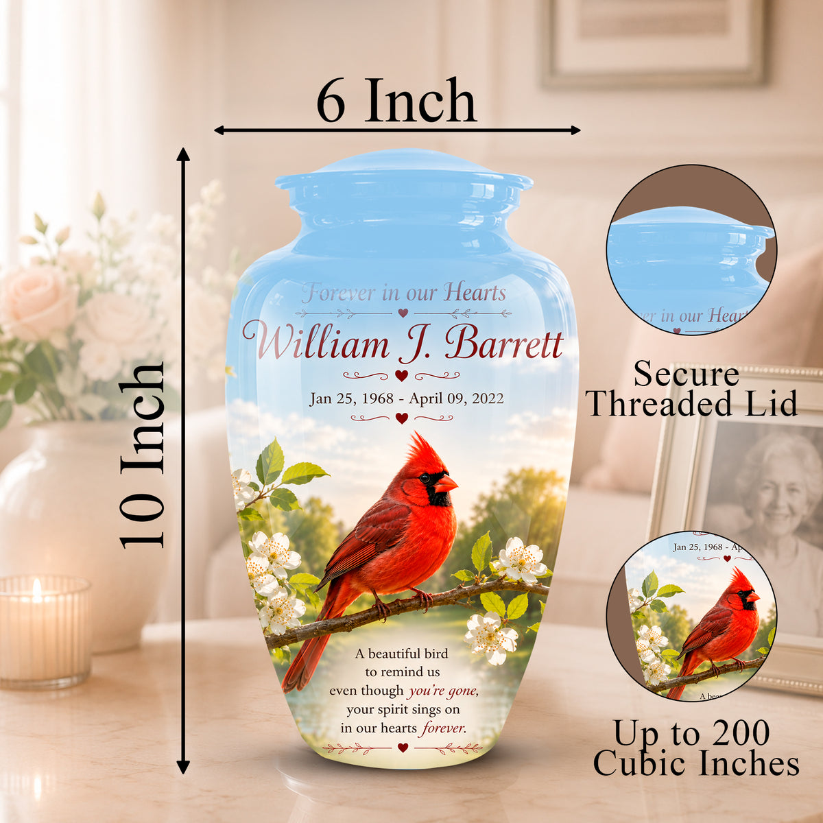 Personalized ceramic memorial urn with a blue lid and printed design of a red cardinal on a branch with white blossoms. The image includes dimension labels showing 6 inch width and 10 inch height, plus circular insets showing the secure threaded lid and the printed design detail, all on a softly lit indoor background.