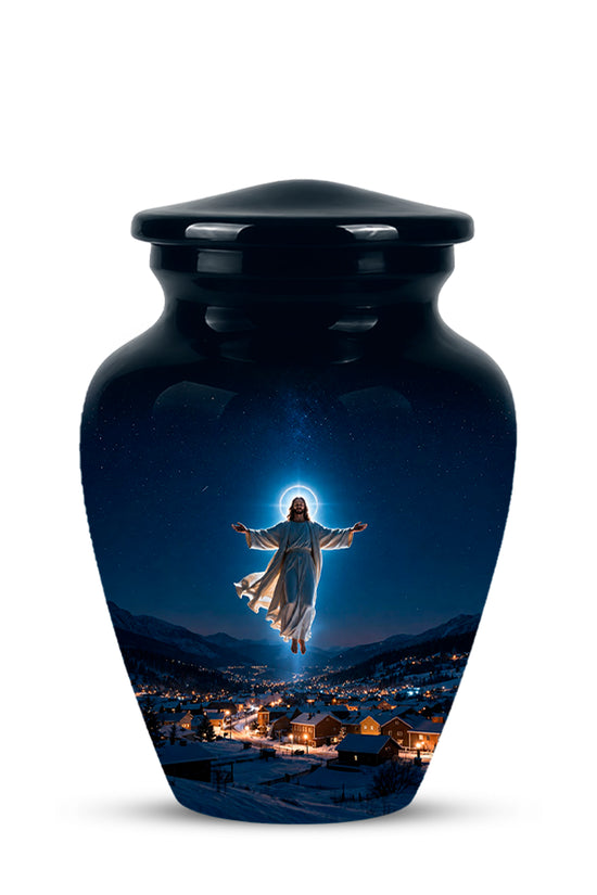 A glossy black ceramic cremation urn with a lid, featuring a printed graphic of Jesus floating above a snowy mountain town at night with a glowing halo.