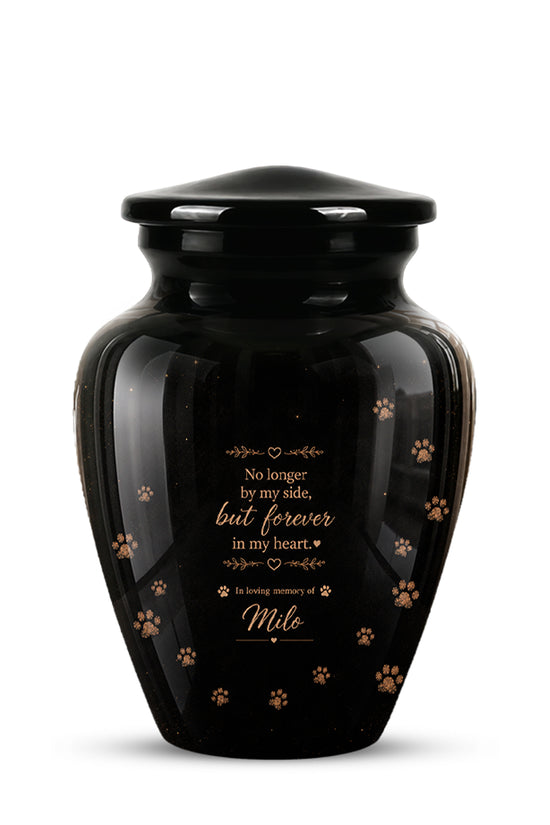 A glossy black pet memorial urn with a matching lid, featuring gold paw prints and a printed sentimental message on the front, set against a plain white background.