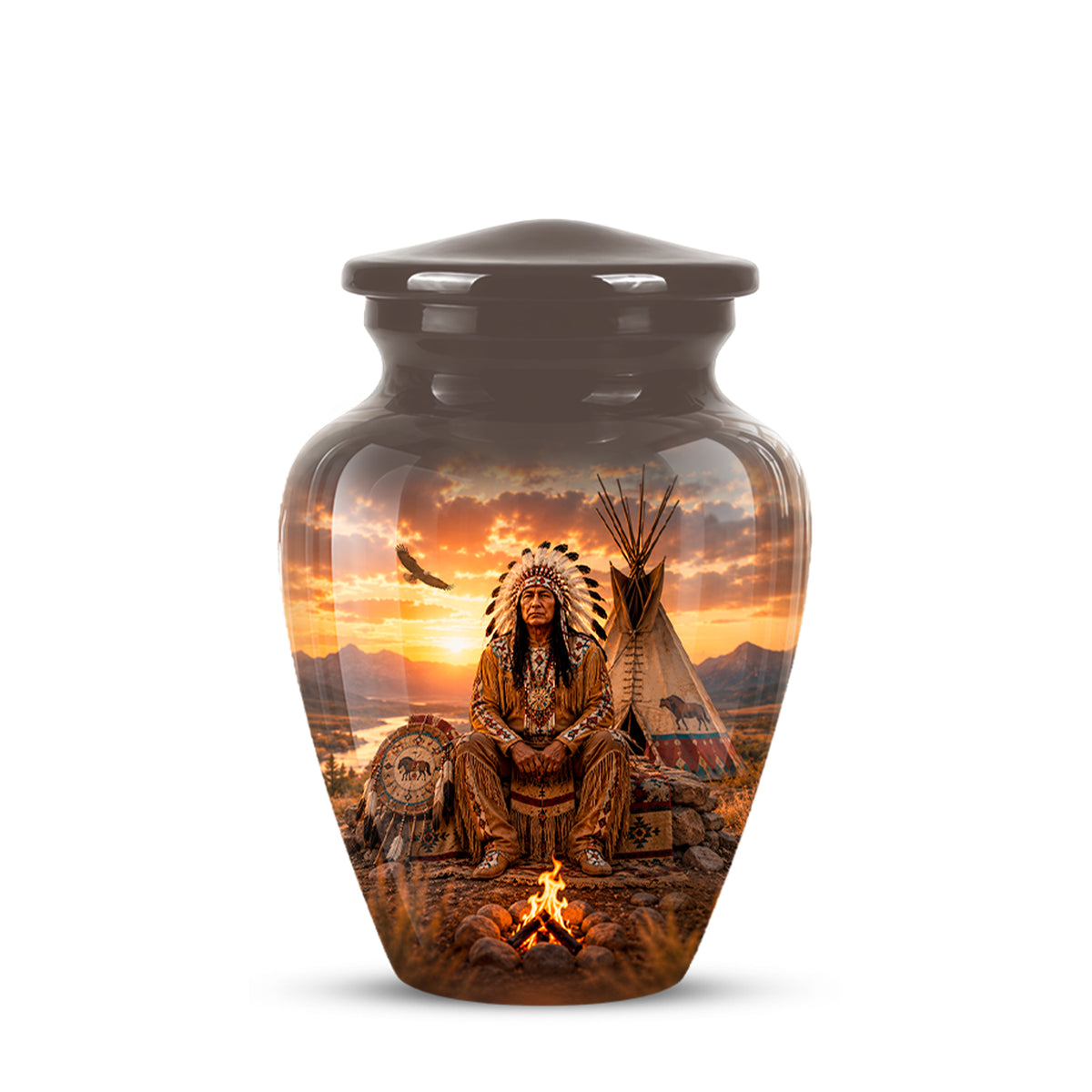 A glossy ceramic memorial urn with a lid, featuring a detailed printed graphic of a Native American figure in a headdress seated by a campfire with a teepee and sunset in the background.