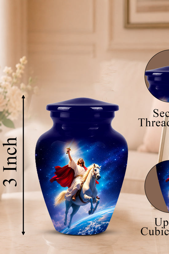 A glossy dark blue urn with a printed celestial scene of Jesus riding a white horse, shown on a tabletop with a vase of flowers and framed photo in the background. Black measurement text reads 3 Inch, with circular inset callouts showing the secure threaded lid and up to 3 cubic inch capacity.