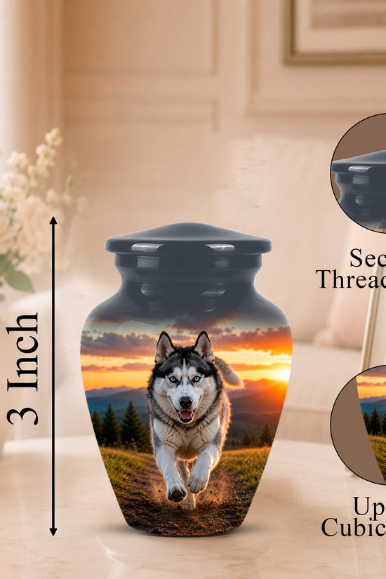 A pet urn vase with a printed husky running at sunset design, shown on a tabletop with a blurred living room background. Black text indicates 3 inch height and includes callout circles for the secure threaded lid and up to 3 cubic inches capacity.