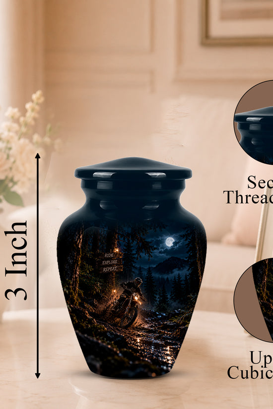 A dark urn-shaped memorial vase with a printed forest night scene, shown on a tabletop in a softly lit room. A vertical arrow labels the height as 3 Inch, and two circular inset close-ups highlight a secure threaded lid and up to 3 cubic inches capacity.
