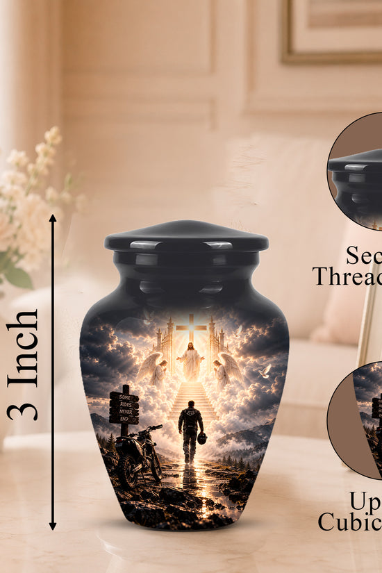 A black cremation urn with a printed religious scene on the front, shown on a tabletop in a softly lit room. The image includes a 3-inch height marker, a close-up inset of the secure threaded lid, and a circular inset showing up to 3 cubic inches of space for a photo.