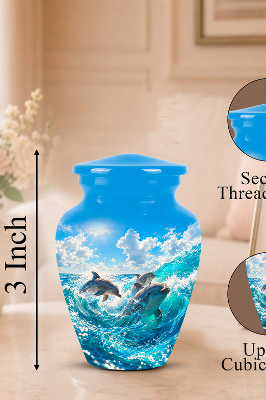 Blue urn-shaped vase with a dolphin ocean print, shown on a table in a softly lit room with size and feature callouts including a secure threaded lid and up to 3 cubic inches capacity.