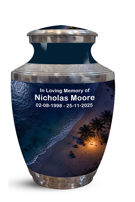 Personalized stainless steel cremation urn with a dark navy blue tropical beach print and silver metallic accents, featuring custom text 'In Loving Memory of Nicholas Moore' on the front.