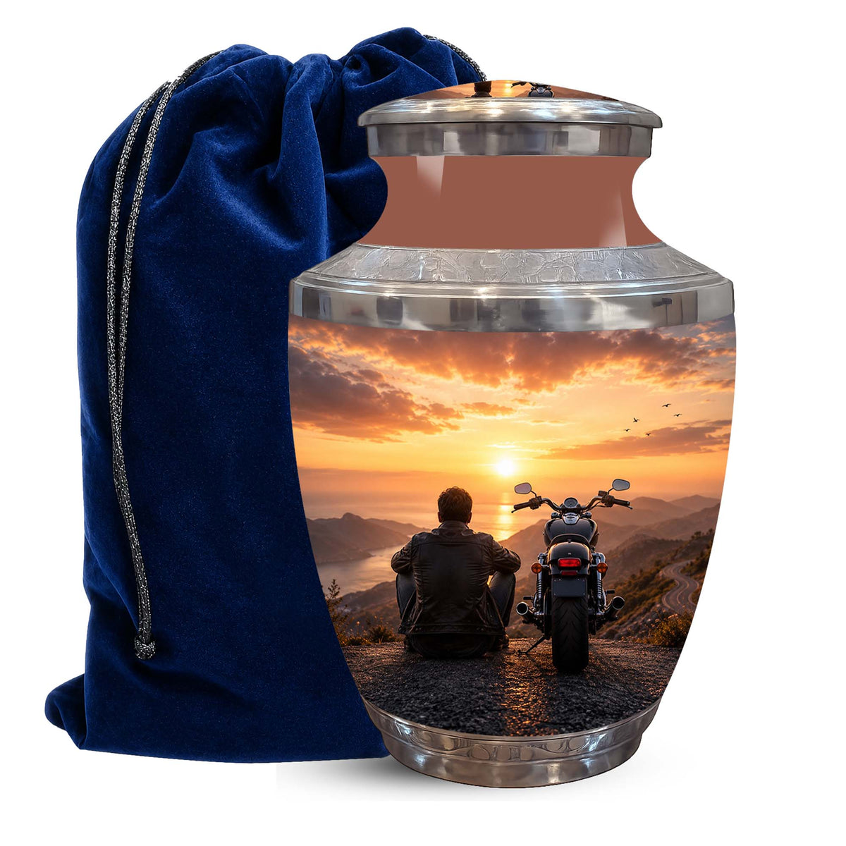A metallic cremation urn with a lid, featuring a printed scenic image of a person sitting on a motorcycle at sunset, next to a dark blue velvet drawstring bag on a white background.