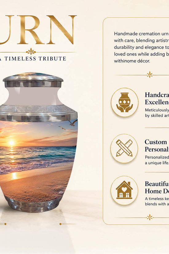 A cremation urn with a beach sunset photo print, shown on a beige promotional background with text reading 'URN' and feature callouts. The urn has a silver-toned lid and base, and a printed scene of a sandy beach at sunset around the middle.