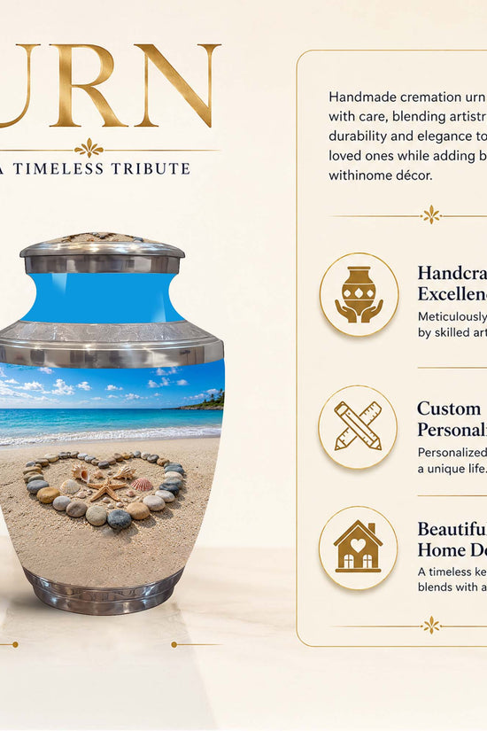 Personalized cremation urn with a beach scene design, shown on a beige background with promotional text and dimensions. The urn has a silver-toned metal top and base, a blue upper band, and a lower section printed with a beach landscape and a heart-shaped stone arrangement on the sand.