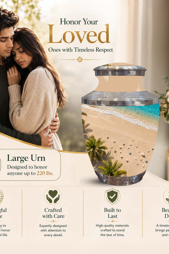 A large decorative memorial urn displayed on a tabletop in a styled interior scene, with a couple shown in the background. The urn contains layered beach scenery with sand, turquoise water, and a small palm tree.